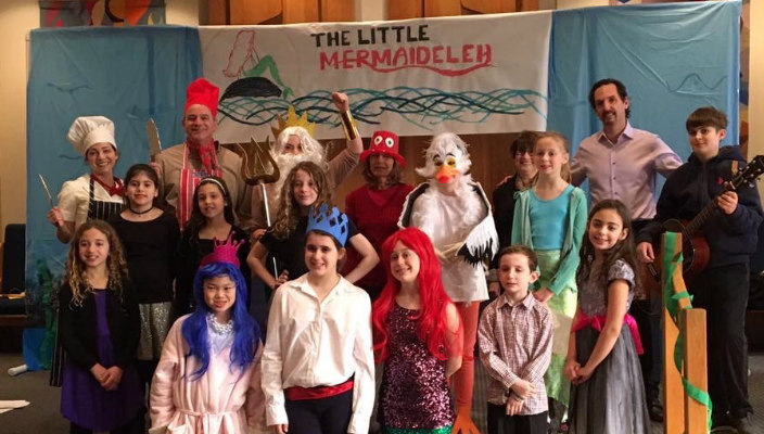 Group of children in costumes under a sign reading THE LITTLE MERMAIDELEH