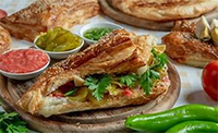 Bourekas are a Sephardic enriched pastry, like puff pastry, and often filled with cheese, potatoes, or a mix of other savory ingredients like mushrooms, spinach, onions