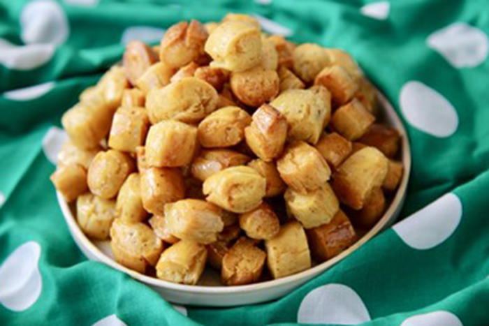 an image of Nuegados which is an Orange and honey fried dough 